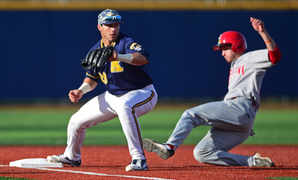 KENT, OHIO - APRIL 13, 2016: Third basemen Dylan Rosa #28 of Kent State keeps his foot on the bag to force out base runner Lorenzo Arcuri #9 of YSU for the 1st out in the top of the 1st inning during Wednesday nights game at Schooner Stadium. DAVID DERMER | THE VINDICATOR