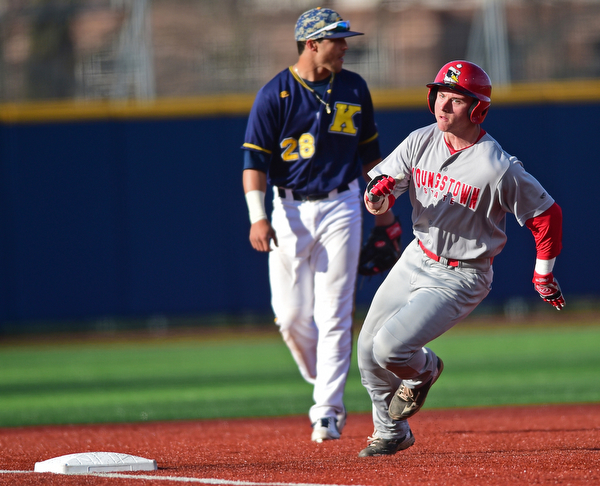 KENT, OHIO - APRIL 13, 2016: Base runner Alex Larivee #19 of YSU rounds third base to head home and score the first run of game in the top of the 1st inning during Wednesday nights game at Schooner Stadium. DAVID DERMER | THE VINDICATOR...Dylan Rosa #28 of Kent State pictured.