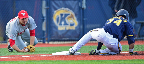 KENT, OHIO - APRIL 13, 2016: Third basemen Nico Padovan #32 of YSU works back to his feet after misplaying the ball allowing base runner Connor Simonetti #34 of Kent State to reach third base in the bottom of the 2nd inning during Wednesday nights game at Schooner Stadium. DAVID DERMER | THE VINDICATOR