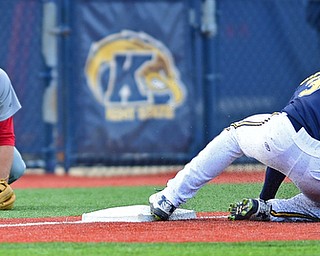 KENT, OHIO - APRIL 13, 2016: Third basemen Nico Padovan #32 of YSU works back to his feet after misplaying the ball allowing base runner Connor Simonetti #34 of Kent State to reach third base in the bottom of the 2nd inning during Wednesday nights game at Schooner Stadium. DAVID DERMER | THE VINDICATOR