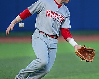 KENT, OHIO - APRIL 13, 2016: Left fielder Alex Larivee #19 of YSU looks for the baseball after it popped out of his glove allowing the Kent State base runner to reach safely in the bottom of the 6th inning during Wednesday nights game at Schooner Stadium. DAVID DERMER | THE VINDICATOR