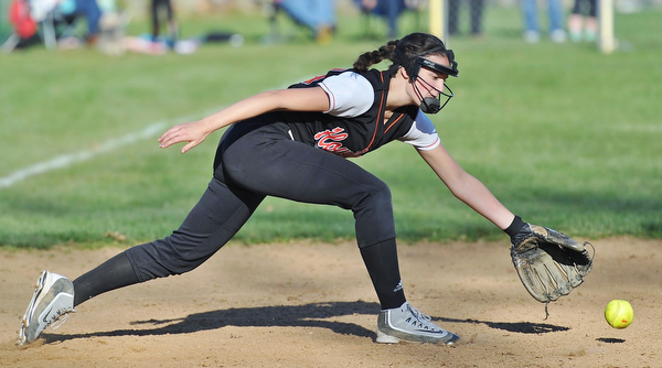 Jeff Lange | The Vindicator  THU, APRIL 14, 2016 - Howland third baseman Kamryn Buckley stretches out in attempt to scoop up a ground ball late in Thursday's game against Boardman at Howland Township Park.