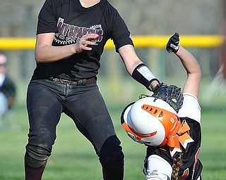 Jeff Lange | The Vindicator  THU, APRIL 14, 2016 - Boardman shortstop Olivia Russell applies the tag to Howland baserunner Gabby Hartzell as slides into second late in Thursday's game at Howland Township Park.