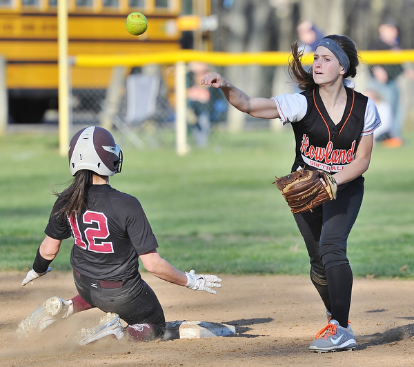 Jeff Lange | The Vindicator  THU, APRIL 14, 2016 - Howland second baseman Emily Darlington (right) makes the throw to first to complete a double play over Boardman baserunner Olivia Russell late in Thursday's game at Howland Township Park.