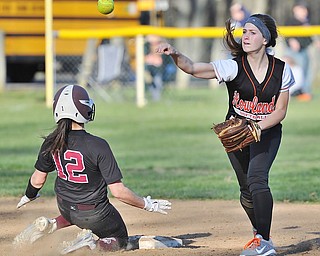 Jeff Lange | The Vindicator  THU, APRIL 14, 2016 - Howland second baseman Emily Darlington (right) makes the throw to first to complete a double play over Boardman baserunner Olivia Russell late in Thursday's game at Howland Township Park.