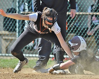 Jeff Lange | The Vindicator  THU, APRIL 14, 2016 - Howland third baseman Kamryn Buckley (left) tags out Boardman baserunner Olivia Russell as she dives toward third base in the first inning of Thursday's game in Howland.