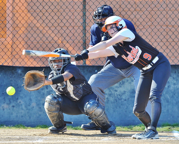 Jeff Lange | The Vindicator  THU, APRIL 14, 2016 - Boardman catcher Miya Mitchum (left) reaches out for a pitch as Howland batter Sara Price takes a swing early in Thursday's game at Howland Township Park.