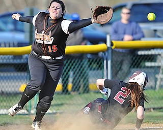 Jeff Lange | The Vindicator  THU, APRIL 14, 2016 - Howland's Hannah Kowach (15) misses a catch as Boardman baserunner Lauren Gabriele slides safely into third during Thursday's game at Howland Township Park.