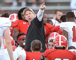 Jeff Lange | The Vindicator  FRI, APRIL 15, 2016 - YSU head coach Bo Pelini gives instructions to players on the field prior to the start of Friday night's spring football game at Stambaugh Stadium in Youngstown.