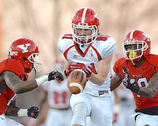 Jeff Lange | The Vindicator  FRI, APRIL 15, 2016 - YSU red team's Tre'von Williams (left) and D.J. Thomas (right) break up a pass intended for white team wide receiver Ryan Emans in the first quarter of Friday night's spring football game at Stambaugh Stadium in Youngstown.