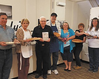 SPECIAL TO THE VINDICATOR
Members of the Recipes of Youngstown Facebook group are preparing for a special tasting event and kitchen dedication in conjunction with Mothers Day weekend. Showing off some of the cuisine to be featured near the Youngstown Steel Kitchen exhibit that’s on display in the Fok Gallery at the Tyler History Center are, from left,  John Heasley, Bobbi Ennett Allen, Keith Evans, Ernie DiRenzo, JoAnn Donahue, Patty Gahagan Ruby and Bobbie Snyder Chalky.