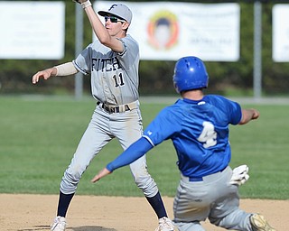 Jeff Lange | The Vindicator  MONDAY, APRIL 18, 2016 - Austintown shortstop Jack Gherardi (11) looks to catch the throw from home to put out Poland baserunner Anthony Calcagni as he attempts to steal second during Monday's game at Poland High School.