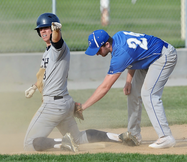 Jeff Lange | The Vindicator  MONDAY, APRIL 18, 2016 - Austintown baserunner Jared Kapturasky (left) points back to the dugout after hitting a triple to right-center field as Poland third baseman Dan Klase attempts to put the tag on him in the top of the fourth inning of Monday's game at Poland High School. Kapturasky later scored to prevent a blowout as Poland dominated 13-1.