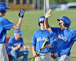 Jeff Lange | The Vindicator  MONDAY, APRIL 18, 2016 - Poland's Dan Drummond (right) high fives Matt Baker (11) after scoring a run in the fourth inning of Monday's game against Austintown Fitch High School.
