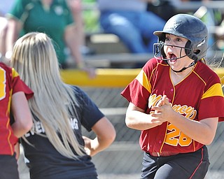 Jeff Lange | The Vindicator  WED, APRIL 20, 2016 - Mooney's Conchetta Rinaldi (right) celebrates as she is met at the plate by teammates after hitting a three-run homer to center field in the first inning of Cardinal Mooney's softball game against Ursuline High School at Fields of Dreams Park in Boardman Wednesday afternoon.