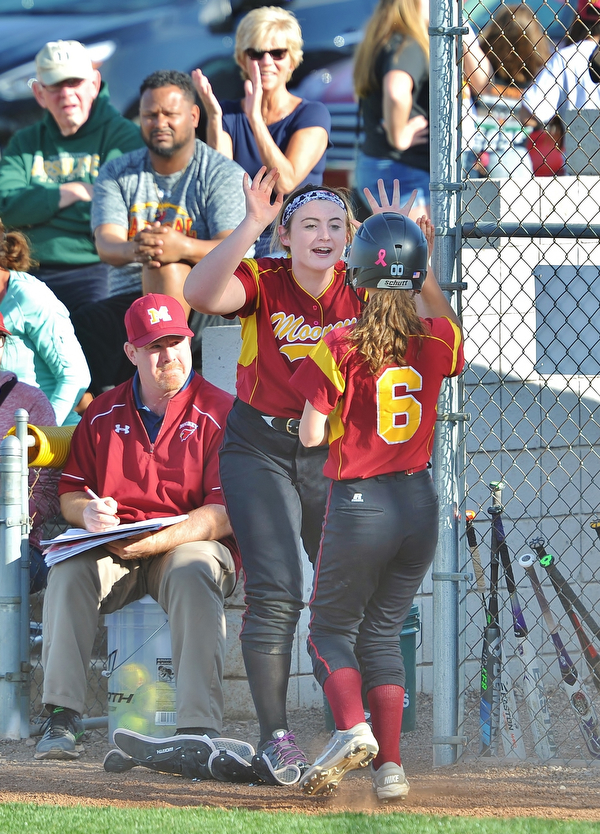 Jeff Lange | The Vindicator  WED, APRIL 20, 2016 - Cardinal Mooney's Kayla Rutherford (facing) celebrates with Brooke Chandler after a run was scored in the fifth inning of Wednesday's game against Ursuline High School in Boardman.