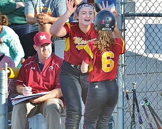 Jeff Lange | The Vindicator  WED, APRIL 20, 2016 - Cardinal Mooney's Kayla Rutherford (facing) celebrates with Brooke Chandler after a run was scored in the fifth inning of Wednesday's game against Ursuline High School in Boardman.