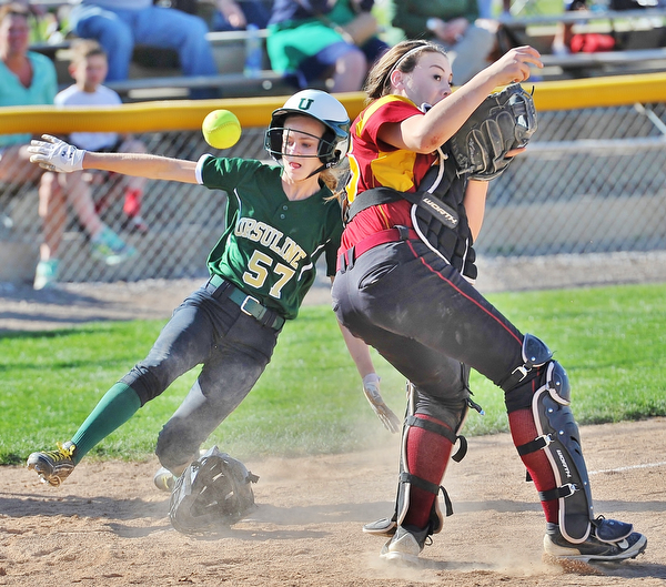 Jeff Lange | The Vindicator  WED, APRIL 20, 2016 - Ursuline baserunner Caroline Aey (57) safely slides home past Mooney catcher Conchetta Rinaldi as Rinaldi misses throw from the outfield in the top of the third inning of Wednesday's game in Boardman.