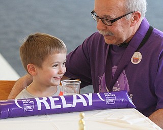 William D Lewis the Vindicator Louie Muche,68, a cancer survivor for 32 years shares a moment with his grandson Louie Muche, 4, during YSU Relay for Life 4-15-16. They are from McDonald.
