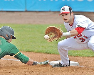 Jeff Lange | The Vindicator  FRI, APRIL 22, 2016 - YSU first baseman Gerrad Rohan looks to catch a throw from the mound as Wright State's Ryan Fucci dives safely into the bag Friday afternoon in Niles.