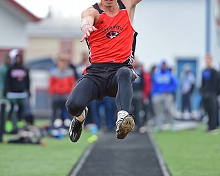 AUSTINTOWN, OHIO - APRIL 23, 2016: Graham Mincher of Springfield flies through the air during his flight of the boys long jump during the 103rd Annual Mahoning County Track & Field Championships. DAVID DERMER | THE VINDICATOR