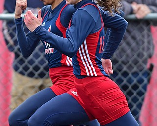 AUSTINTOWN, OHIO - APRIL 23, 2016: Eva Rivera and Tyra Barnes both of Fitch race each other to the finish line during their heat of the girls 100 meter dash during the 103rd Annual Mahoning County Track & Field Championships. DAVID DERMER | THE VINDICATOR