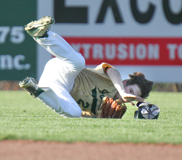 William D Lewis  The Vindicator Ursuline's (27) is upended as he catches a fly ball during 4-24-16 loss to Mooney at Cene.