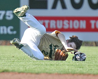 William D Lewis  The Vindicator Ursuline's (27) is upended as he catches a fly ball during 4-24-16 loss to Mooney at Cene.