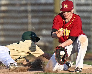 William D Lewis  The Vindicator  Ursuline's (12) beats the throw back to Mooney firstbaseman (11) during 4-24-16 game at Cene.