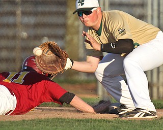 William D Lewis  The Vindicator Mooney's 11 beats the throw back to first as Ursuline #26 waits for the ball during 4-24-16 action at Cene.