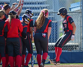 KENT, OHIO - APRIL 27, 2016: Miranda Castiglione #17 of YSU jumps onto home plate while being welcomed by her teammates after hitting a go ahead grand slam in the 7th inning of Wednesday night at the Diamond at Dix. YSU won game one 7-6. DAVID DERMER | THE VINDICATOR