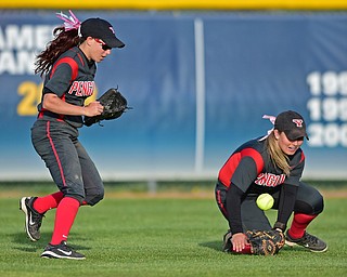 KENT, OHIO - APRIL 27, 2016: Cali Mikovich #4 of and Brittney Moffatt #2 of YSU watch as the softball falls to the turf after the ball popped out of the glove of Mikovich in shallow right field allowing a Kent State runner to reach base in the sixth inning of game two Wednesday night at the Diamond at Dix. Kent State won game two 3-2. DAVID DERMER | THE VINDICATOR