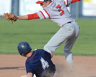 Jeff Lange | The Vindicator  WED, APRIL 27, 2016 - Niles second baseman Jaret Johnson (3) steps on the bag for the out as Fitch baserunner Kole Klasic slides in the fourth inning of Wednesday's game at Austintown Fitch High School.