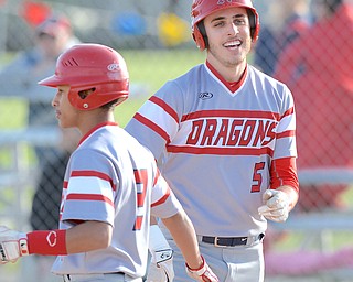 Jeff Lange | The Vindicator  WED, APRIL 27, 2016 - Niles' Richard Limongi (5) celebrates at the plate with teammate Tre Martin after Limongi scored a run in the top of the fifth inning of Wednesday's game at Ausintown Fitch High School.