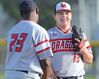 Jeff Lange | The Vindicator  WED, APRIL 27, 2016 - Niles starting pitcher Tyler Srbinovich shares a moment of laughter with third baseman Damion Coleman (23) at the mound late in Wednesday's game at Austintown Fitch High School.