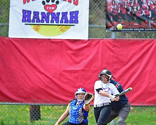 STRUTHERS, OHIO - APRIL 30, 2016: Erika Bayer #13 of Struthers drives the ball for a base hit in the second inning of Saturday mornings game against Valley Christian. A Wildcats for Hannah banner hangs on the back stop showing their support for Hannah Tringhese. DAVID DERMER | THE VINDICATOR