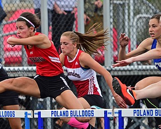 POLAND, OHIO - APRIL 30, 2016: Emily Marsico of Girard clears a hurdle while leading the pack of Courtney Cyrus of Springfield, Amanda Milo of CVCA, Deanna Ogrinc of Chardon and Charity Hall of Harding in the girls 100 meter hurdles finals Saturday afternoon during the Poland Invitational at Poland High School. DAVID DERMER | THE VINDICATOR