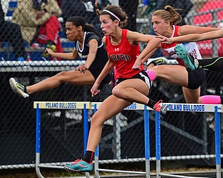 POLAND, OHIO - APRIL 30, 2016: Emily Marsico of Girard clears a hurdle while leading Deanna Ogrinc of Chardon and Charity Hall of Harding in the girls 100 meter hurdles finals Saturday afternoon during the Poland Invitational at Poland High School. DAVID DERMER | THE VINDICATOR