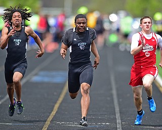 POLAND, OHIO - APRIL 30, 2016: Dez'meon Allen sprints to the finish line ahead of Imoni Donadalle of East and Jimmy Vaughn of Niles during the boys 100 meter dash final Saturday afternoon during the Poland Invitational at Poland High School. DAVID DERMER | THE VINDICATOR