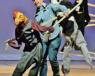 Jeff Lange | The Vindicator  SAT, APRIL 9, 2016 - Youngstown's Kyle Shehadi of Sigma Tau Gamma grins as he performs a dance with a chicken and cow puppet to a greatest hits of the 90s medley during Saturday night's The 90's Greeksing held at Stambaugh Auditorium.