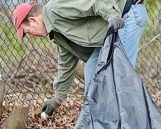 Jeff Lange | The Vindicator  SAT, APRIL 30, 2016 - John Potter of Youngstown picks up trash Saturday morning during the Boys and Girls Club backyard cleanup in Youngstown.