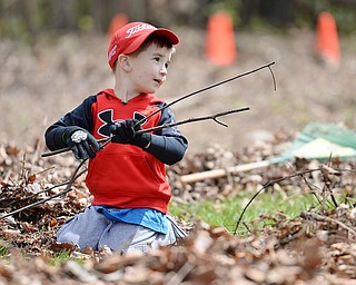 Jeff Lange | The Vindicator  SAT, APRIL 30, 2016 - Three-year-old Garrett Scarsella of Canfield helps pick up sticks during the Boys and Girls Club backyard cleanup in Youngstown Saturday afternoon. Garrett attended the cleanup with his mother Julie Scarsella of Canfield.