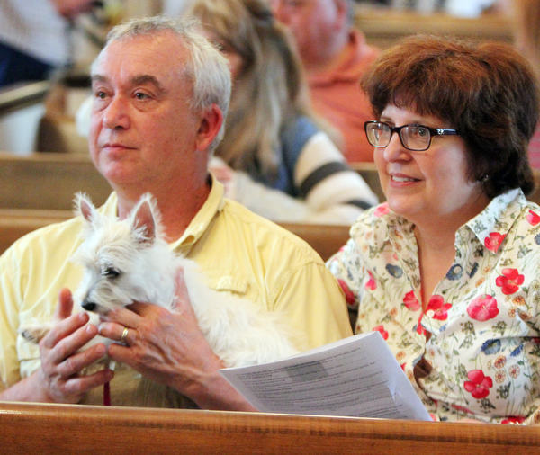 William d Lewis the Vindicator   Butch Merrill and Jody Musitano of Bordman hold their dog "Charlotte" during pet blessing 5-1-16 at St James Episcopal in boardman.