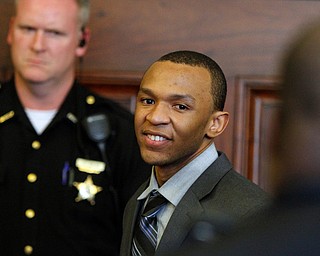   ROBERT K YOSAY | THE VINDICATOR..Michael Austin is clean shaven  laughs as he is cuffed after being found guilty..A jury today in Mahoning County Common Pleas Court has found Michael Austin, 22, guilty of three counts of murder, one count of murder and engaging in a pattern of corrupt activity..Austin was found not guilty of a separate charge of attempted murder..Hakeem Henderson, 24, was found guilty of two counts of aggravated murder, not guilty of two counts of aggravated murder, and engaging Ina pattern of corrupt activity...--30-