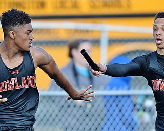 Jeff Lange | The Vindicator  THU, MAY 5, 2016 - Howland's Jacob Williams (left) looks to take the handoff from Jordan Lanier in the boys 4x200 meter relay during Thursday's track meet at Lakeview High School.