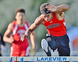 Jeff Lange | The Vindicator  THU, MAY 5, 2016 - Girard's Collin Harden clears a hurdle ahead of Labrae's Keevon Harris in the boys 300 meter hurdles during Thursday's track meet in Cortland.