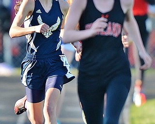 Jeff Lange | The Vindicator  THU, MAY 5, 2016 - McDonald's Heidi Hoffman (left) looks to lap a Howland competitor as she runs to finish line to claim first in the girls 3,200 meter run during Thursday's track meet in Cortland.
