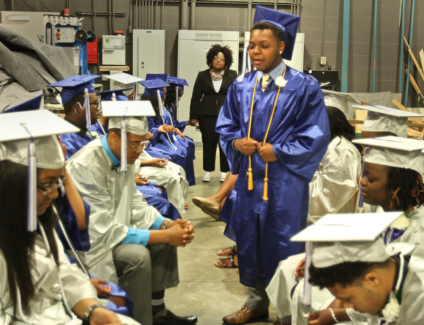 William d Lewis the vindicator  YEC graduate Jordan Rawl leads fellow grads in prayer before comencement ceremony 5-6-16 .