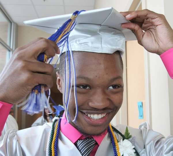William d Lewis the vindicator  YEC graduate Richard Watson adjusts his tassel before comencement ceremony 5-6-16 .