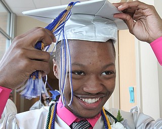 William d Lewis the vindicator YEC graduate Richard Watson adjusts his tassel before comencement ceremony 5-6-16 .